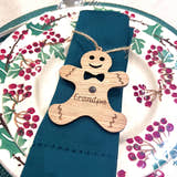 Load image into Gallery viewer, Napkin holder shaped like a gingerbread man with 'Grandpa' engraved, on a blue napkin with a decorative plate in the background.