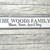 Load image into Gallery viewer, Family nameplate with 'The Woods Family' on a wooden surface with flowers.
