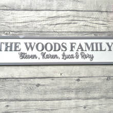 Load image into Gallery viewer, Family nameplate with 'The Woods Family' on a wooden surface with flowers.