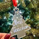 Load image into Gallery viewer, Decorative ornament shaped like a tree with 'Best Teacher' text, held in front of a Christmas tree.