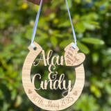 Load image into Gallery viewer, Personalised oak wooden wedding horseshoe engraved with names and wedding date, perfect as a bridal bouquet charm or keepsake gift.
