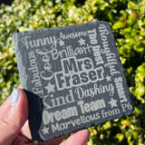 Load image into Gallery viewer, A hand holding a black slate coaster with laser engraved text that includes a teacher's name and personalized phrases such as 'Brilliant', 'Fabulous', and 'Awesome'.