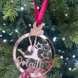 Load image into Gallery viewer, A pink circular Christmas tree decoration with a gymnast figure in the center, hanging on a Christmas tree.