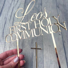 Load image into Gallery viewer, Gold 'Leo's First Holy Communion' cake topper with a cross on a wooden surface.