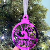 Load image into Gallery viewer, A pink circular Christmas tree decoration with a gymnast figure in the center, hanging on a Christmas tree.