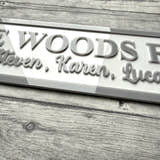 Load image into Gallery viewer, acrylic sign with 'The Woods Family' and names on a acrylic surface