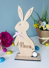 Load image into Gallery viewer, Personalised wooden Easter bunny decoration, engraved with custom name. Perfect for Easter gifts, baskets, and festive home decor