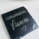 Load image into Gallery viewer, A slate coaster with the words 'girlfriend' and 'fianée' laser engraved on it, indicating a change in relationship status.