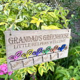 Load image into Gallery viewer, Personalised Grandad’s Greenhouse wooden sign with little helpers welcome text and 6 plant pots with childrens names hanging in a garden