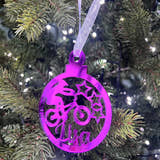 Load image into Gallery viewer, A purple Christmas tree decoration with a laser cut and engraved design, hanging on a tree with lights and a name 'Liam' written on it.