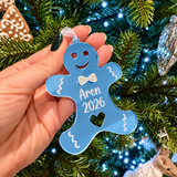Load image into Gallery viewer, Personalised blue acrylic gingerbread Christmas ornament engraved with Aren 2026 on a Christmas tree