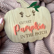 Load image into Gallery viewer, Wooden pumpkin-shaped sign with 'Cutest Pumpkin in the Patch' text on a textured fabric background