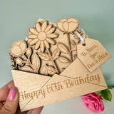 Load image into Gallery viewer, Wooden card with floral design and 'Happy 80th Birthday' text, held by a hand.