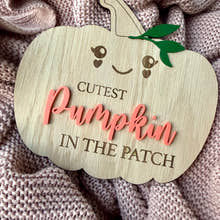 Load image into Gallery viewer, Wooden pumpkin-shaped sign with 'Cutest Pumpkin in the Patch' text on a textured fabric background