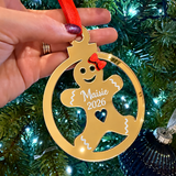 Load image into Gallery viewer, Personalised mirror gold acrylic gingerbread Christmas tree decoration engraved with Maisie 2026 and finished with a red ribbon