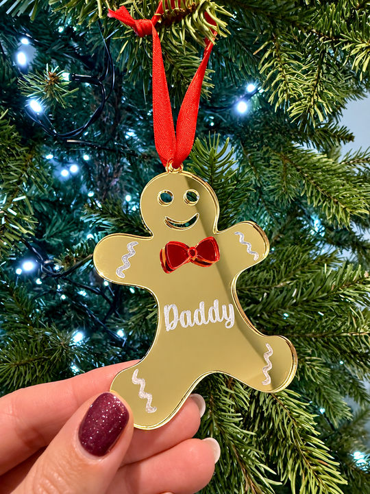 Personalised blue acrylic gingerbread Christmas ornament engraved with Daddy on a Christmas tree