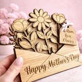 Load image into Gallery viewer, Wooden card with floral design and 'Happy Mother's Day' text, held by a hand against a pink background.