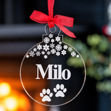 Load image into Gallery viewer, Personalised dog Christmas decoration with name, paw prints and snowflakes on a clear acrylic bauble