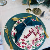 Load image into Gallery viewer, Christmas dinner table setting with personalised acrylic place name ‘Grandad’ in red, festive plate and green napkin