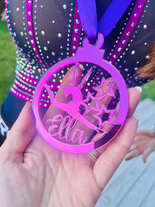 Pink gymnast medal being held by hand