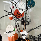 Load image into Gallery viewer, Personalised ghost Halloween tree decoration with engraved name hanging on a Halloween tree with pumpkins and spooky ornaments.
