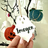 Load image into Gallery viewer, Personalised ghost Halloween tree decoration with engraved name hanging on a Halloween tree with pumpkins and spooky ornaments.