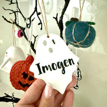 Load image into Gallery viewer, Personalised ghost Halloween tree decoration with engraved name hanging on a Halloween tree with pumpkins and spooky ornaments.