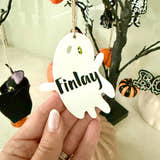Load image into Gallery viewer, Personalised ghost Halloween tree decoration with engraved name hanging on a Halloween tree with pumpkins and spooky ornaments.
