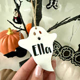 Load image into Gallery viewer, Personalised ghost Halloween tree decoration with engraved name hanging on a Halloween tree with pumpkins and spooky ornaments.