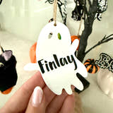 Load image into Gallery viewer, Personalised ghost Halloween tree decoration with engraved name hanging on a Halloween tree with pumpkins and spooky ornaments.