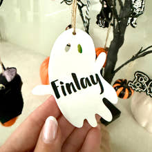 Load image into Gallery viewer, Personalised ghost Halloween tree decoration with engraved name hanging on a Halloween tree with pumpkins and spooky ornaments.