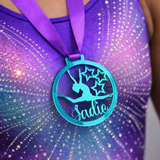 Load image into Gallery viewer, personalised gymnastics medal worn proudly by a gymnast wearing a leotard with custom name design