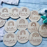Load image into Gallery viewer, Personalised wooden baby milestone discs with rainbow theme, engraved with baby's milestones. Perfect for newborn gifts, baby showers, and capturing special moments.