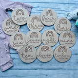 Load image into Gallery viewer, Personalised wooden baby milestone discs with rainbow theme, engraved with baby's milestones. Perfect for newborn gifts, baby showers, and capturing special moments.
