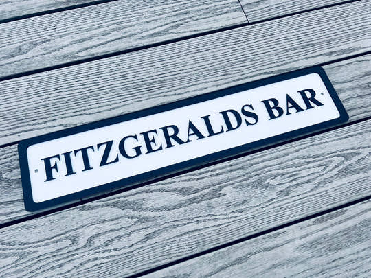 Personalised bar name sign mounted on outdoor wall, perfect for home bar, man cave, or garden pub decor