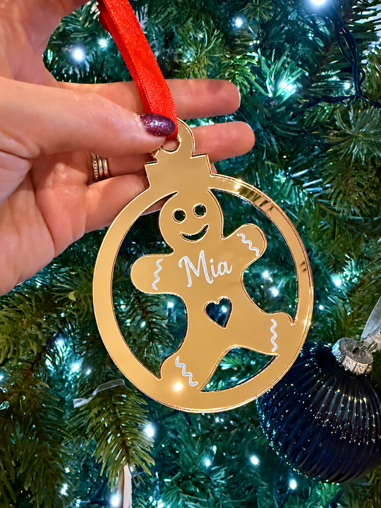 Personalised acrylic gingerbread ornament with red bow, icing details and heart cut-out