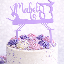 Load image into Gallery viewer, Personalised lilac acrylic gymnastics birthday cake topper with custom name and age on white cake decorated with purple and pink buttercream swirls and sprinkles.