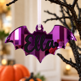 Load image into Gallery viewer, Personalised bat Halloween tree decoration in purple mirrored acrylic with the name in black