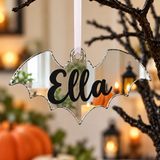 Load image into Gallery viewer, Personalised bat Halloween tree decoration in silver mirrored acrylic with the name in black
