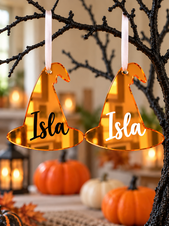 Two orange witch hat Halloween tree decorations showing the name in black and in white vinyl