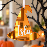 Load image into Gallery viewer, Personalised witch hat Halloween tree decoration in orange mirrored acrylic with the name in white