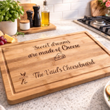 Load image into Gallery viewer, Custom engraved bamboo cheeseboard with personalised names and cheese quote on modern kitchen countertop.