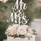 Load image into Gallery viewer, Silver mirror acrylic Mr and Mrs wedding cake topper on a white buttercream wedding cake with blush roses and greenery.