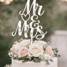 Load image into Gallery viewer, Silver mirror acrylic Mr and Mrs wedding cake topper on a white buttercream wedding cake with blush roses and greenery.