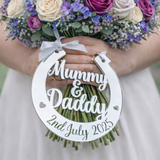 Load image into Gallery viewer, Personalised silver mirror wedding horseshoe gift for bride engraved Mummy & Daddy 2nd July 2025 hanging from bouquet