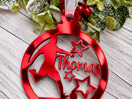 Personalised footballer Christmas tree decoration in red mirrored acrylic with the name Thomas
