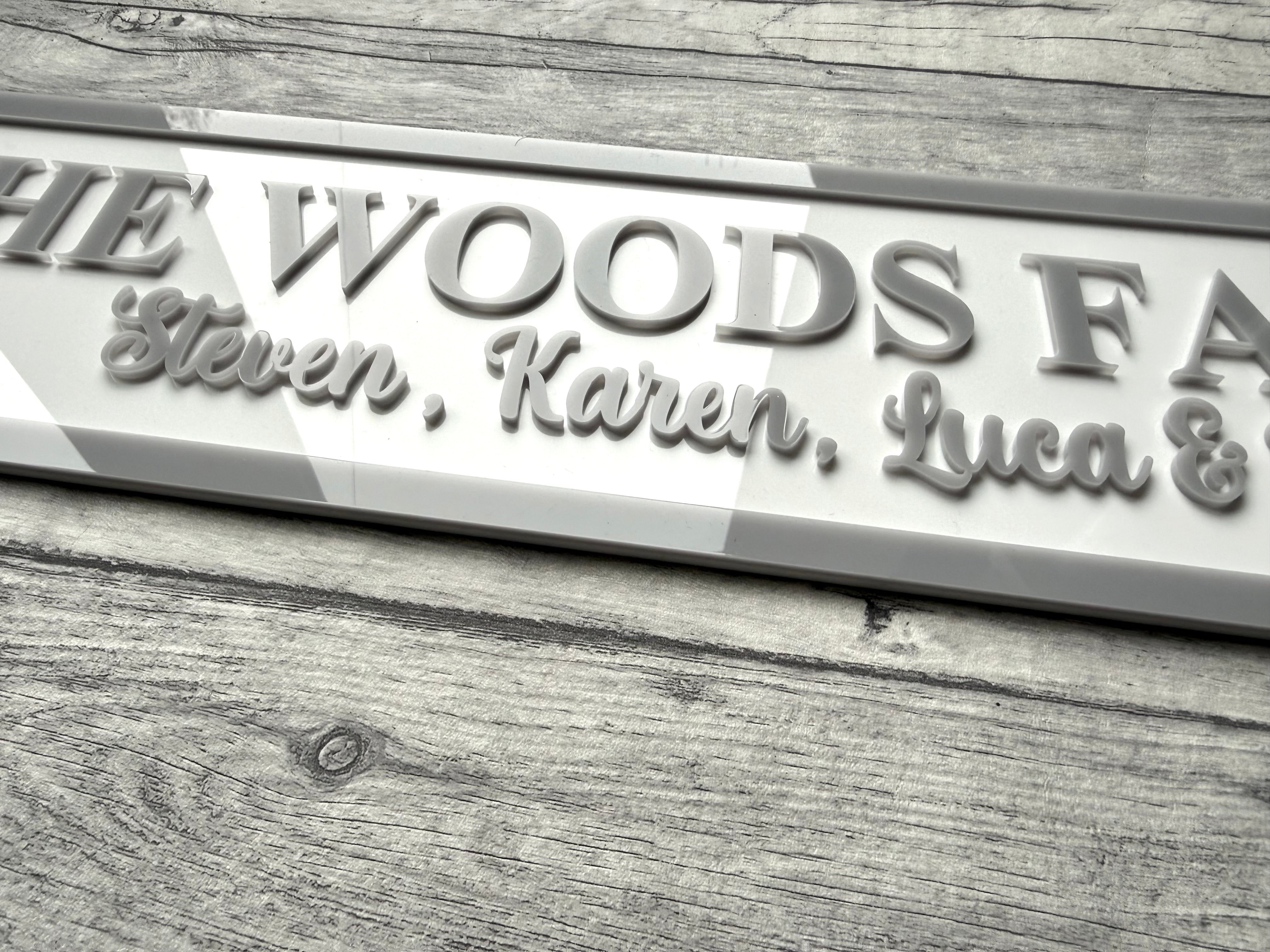 Load image into Gallery viewer, acrylic sign with 'The Woods Family' and names on a acrylic surface

