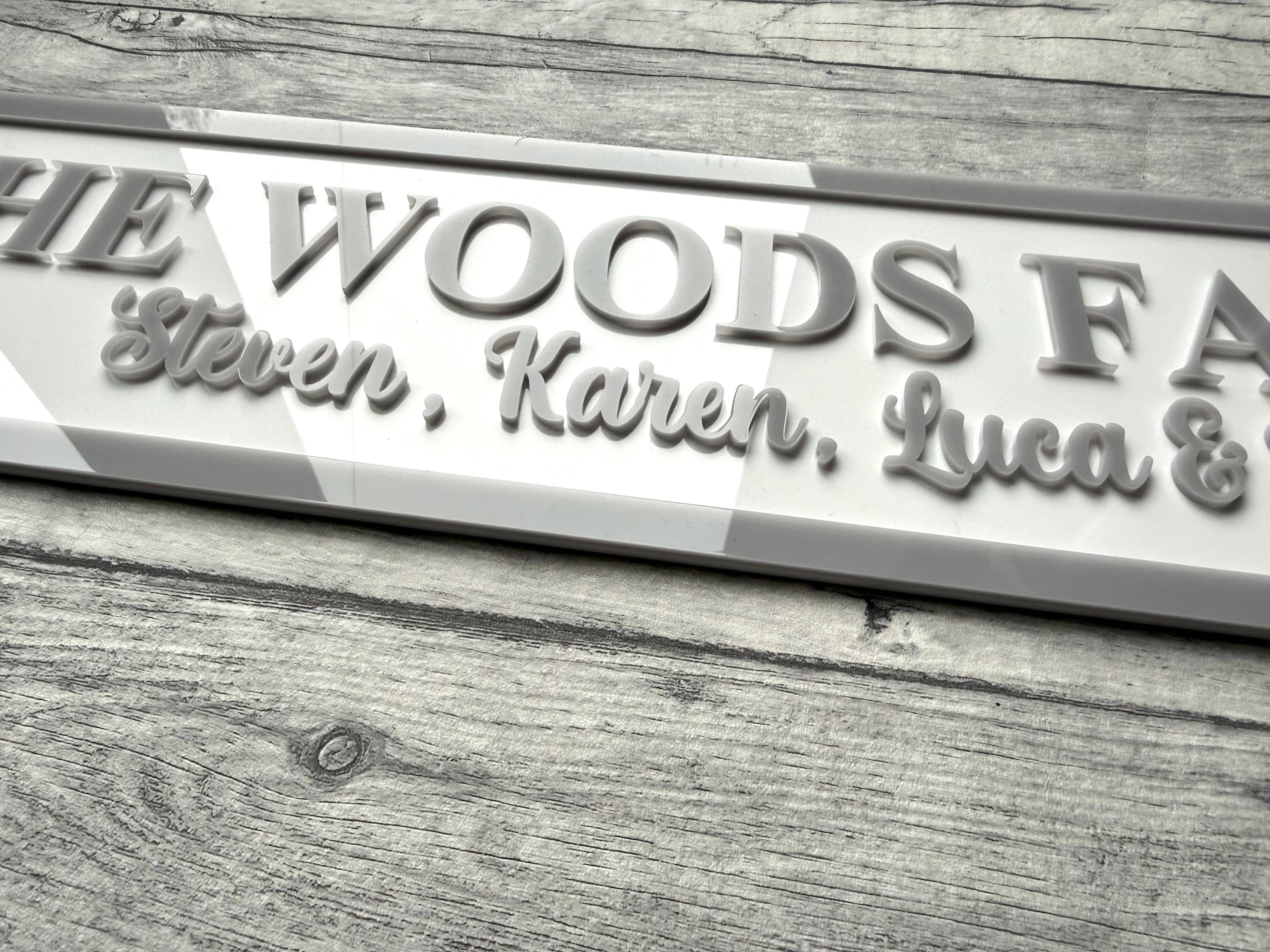 acrylic sign with 'The Woods Family' and names on a acrylic surface