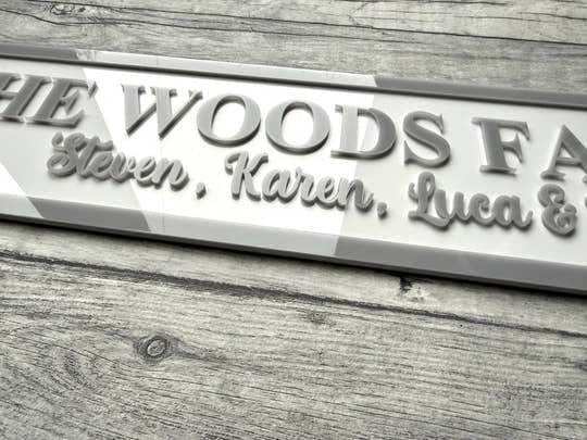 acrylic sign with 'The Woods Family' and names on a acrylic surface