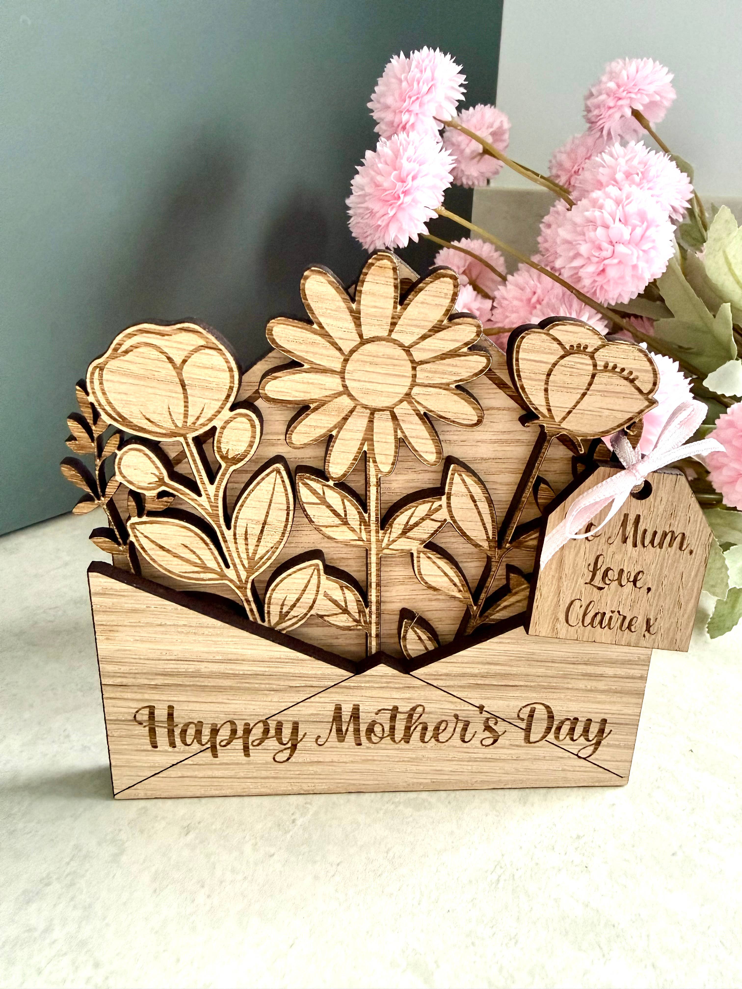 Personalised wooden Mothers day card with ‘Happy Mother’s day’ laser engraved on the front and a wooden gift tag with personalised gift details. 